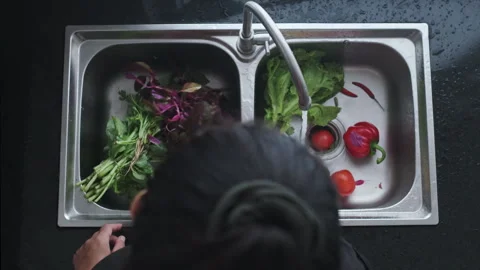 Top Above View of Kitchen Sink with Faucet. A lot of Fresh and Clean Green Salad Stock Footage 273130992