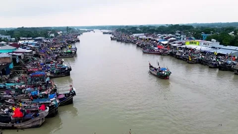 Top Aerial 4K View of a River Surrounded by Bright, Colorful Fishing Boats Stock Footage 322178153