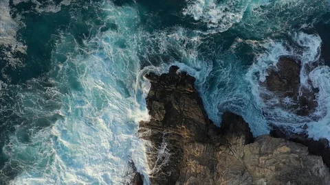 Top aerial drone view of waves crashing on rocky coastline. Blue ocean, wave and Stock Footage 127322973