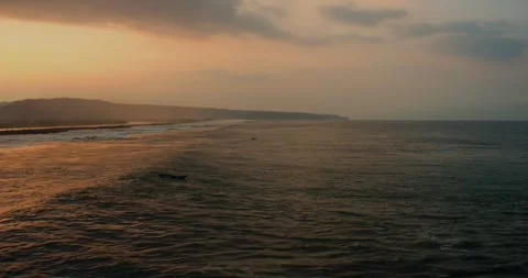 Top aerial perspective of ocean waves touching tropical sandy beach at sunrise Stock Footage 329460954