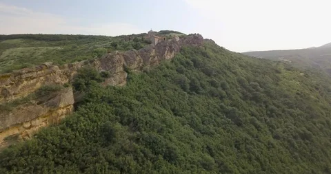 Top Aerial side fly view on a Monastery complex located in rocks of mountains Stock Footage 110685349