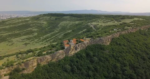Top Aerial side overhead view on a Monastery complex in rocks of mountains Stock Footage 110687540