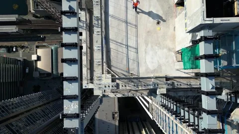 Top aerial view of construction worker walk in project building area Stock Footage 240130045