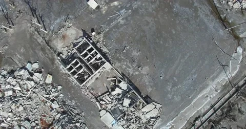 Top aerial view of destroyed town, transformed into rubble after disaster. Stock Footage