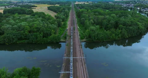 Top aerial view of a freight train moving through a beautiful autumn forest Stock Footage 247335616