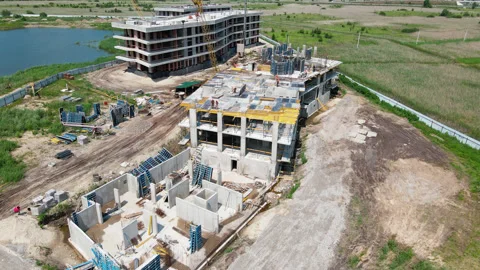 Top aerial view of a massive construction site with a house in a city Stock Footage 135166801