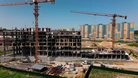 Top aerial view of a massive construction site with a house in a city Stock Footage 137424751