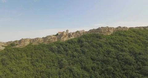 Top Aerial view on a Monastery complex located in rocks of mountains Stock Footage 110679615