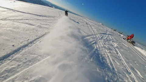 Top aerial view in mountains two guys on snowmobile jumps and rides in the Stock Footage 189406860