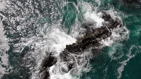 Top aerial view of ocean waves splash against rocks background, Stock Footage 139816738