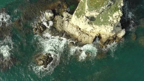 Top aerial view of ocean waves splash against rocks background. Stock Footage 143114280