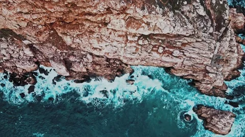 Top aerial view of ocean waves splash against rocks background, Stock Footage 148482530