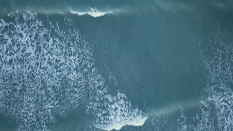 Top aerial view of waves breaking at shore Stock Footage 102511690