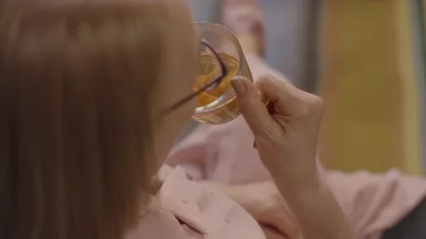 Top and back angle, old woman drinking herbal tea. Stock Footage 148688345