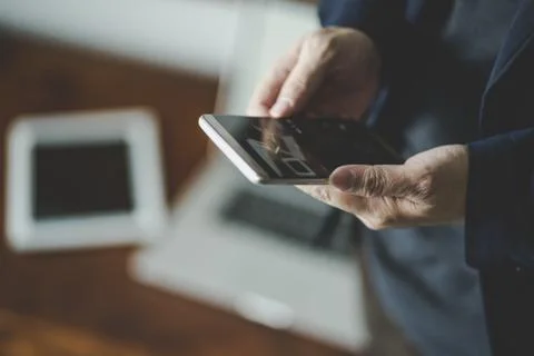 Top angle and closeup view  of businessman using the smartphone with blur lap Stock Photos