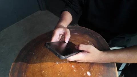 Top Angle Close Up Person Holding Phone On Wooden Table Stock Footage Stock Footage 341396089