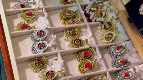 Top-angle close-up view of a collection of handcrafted gold and silver tradition Stock Footage 347151735