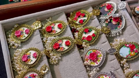 Top-angle close-up view of a collection of handcrafted gold and silver tradition Видео 347154887