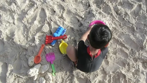 Top Angle Footage of A Boy Play With Toys On Beach Stock Footage 157851996