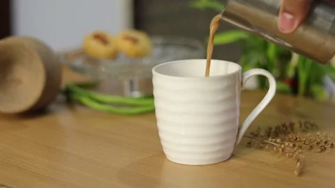 Top angle of pouring refreshing tea in a white cup. Stock Footage 245096331
