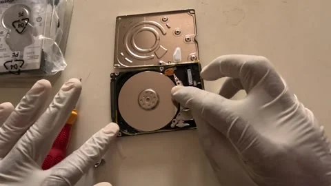 TOP ANGLE SCENE TECHNICIAN REPAIRING HARD DISK Stock Footage 247817922