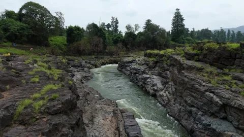 Top angle shot of Dam water flowing through the rock. Video stock 285430140