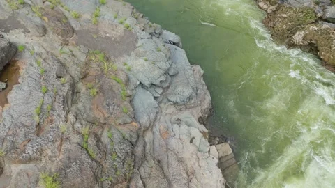 Top angle shot of Dam water flowing through the rock. Video stock 285476364