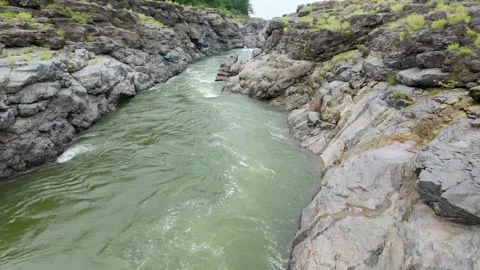 Top angle shot of Dam water flowing through the rock. Video stock 285476475