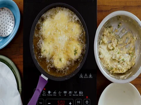 Top-angle shot-Deep Frying vada Stock Footage 80454111