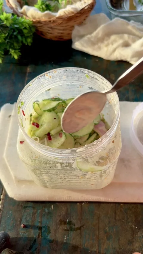Top Angle shot of Delicious cucumber salad in a glass jar. Stock Footage 286216571
