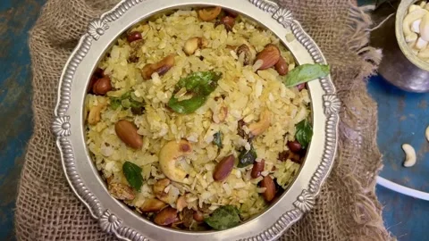 Top angle shot of Indian Snack chivda namkeen garnished with cashew and peanuts Stock Footage 287177213