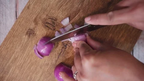 Top angle shot of onion cutting on a chopping board. Stock Footage 282766557