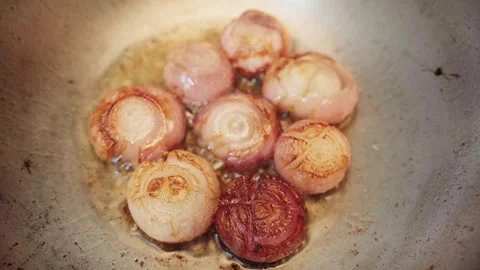 Top angle shot of onion frying in a cauldron or pan. Stock Footage 282567488