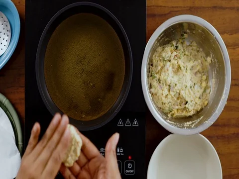 Top-angle shot -Shaping and Deep Frying of Vada 動画素材 80455125