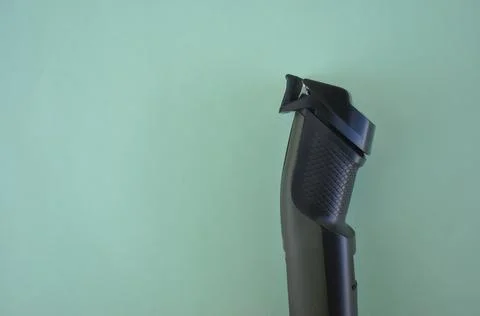 Top angle of side view of beard trimmer with attached comb with negative space Stock Photos