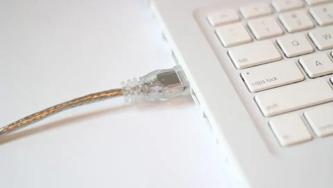 Top angle - Unplugging/plugging in Firewire cable jack (clear cable) Stock Footage 4501088