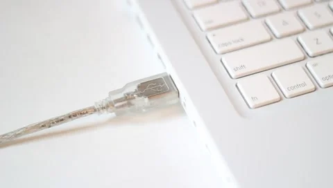 Top angle - Unplugging/plugging in USB computer jack socket (clear cable) Stock Footage 4501370