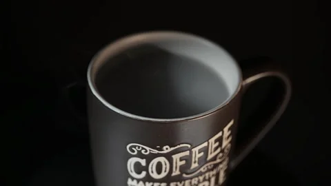 Top-Angle View of a Black Ceramic Coffee Mug on a Dark Surface Stockbeeldmateriaal 337119881
