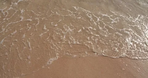 Top angle view of clean sea waves breaking on sandy beach. Stock Footage 277946876