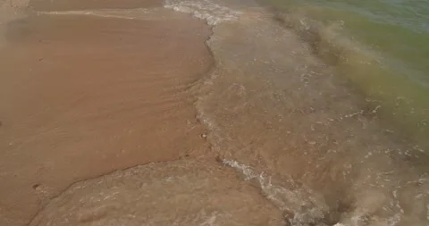 Top angle view of clean sea waves breaking on sandy beach. Stock Footage 277990505