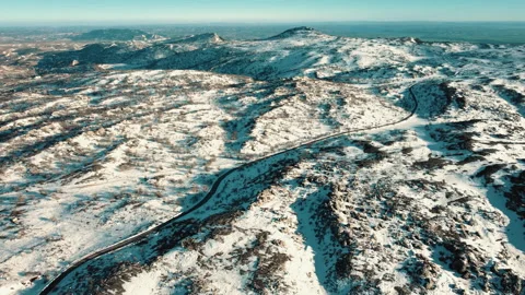 Top angle view drone video of a vehicle coming on snowy road Stock Footage 236963943