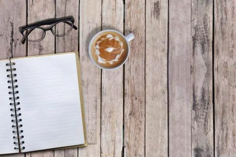 Top angle view of empty book and hot coffee on old desk, copy space Stock Photos