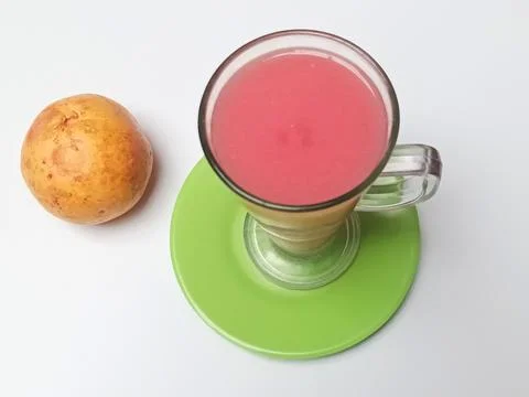 Top Angle View of Fresh Pink Guava Juice Glass and Ripe Fruit 库存照片