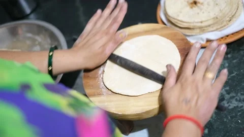 Top angle view of Indian woman making roti in the kitchen area. Stock Footage 239721663