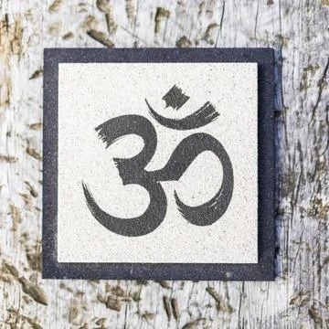 Top angle view of an Om sign on tree trunk. Yoga and meditation concept. Stock Photos