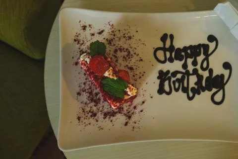 Top angle view of a piece of red velvet birthday cake with happy birthday c.. Stock Photos
