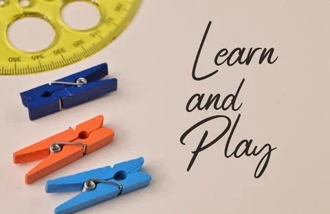 Top angle view of ruler and clothespins over white background written with LE Stock-Fotos