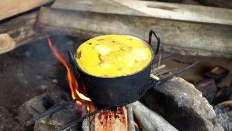Top angle view of yellow curry stew with potato or tofu chunks cooking Stock Footage 345476719