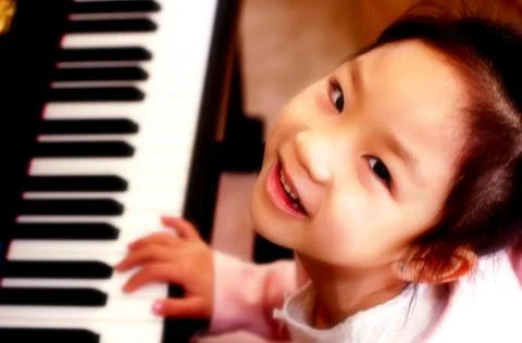 Top angle view of young girl playing piano Stock Photos