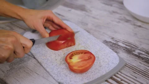 Top angle view zooming out hands approaching to tomato lying on cutting board Video stock 277083346